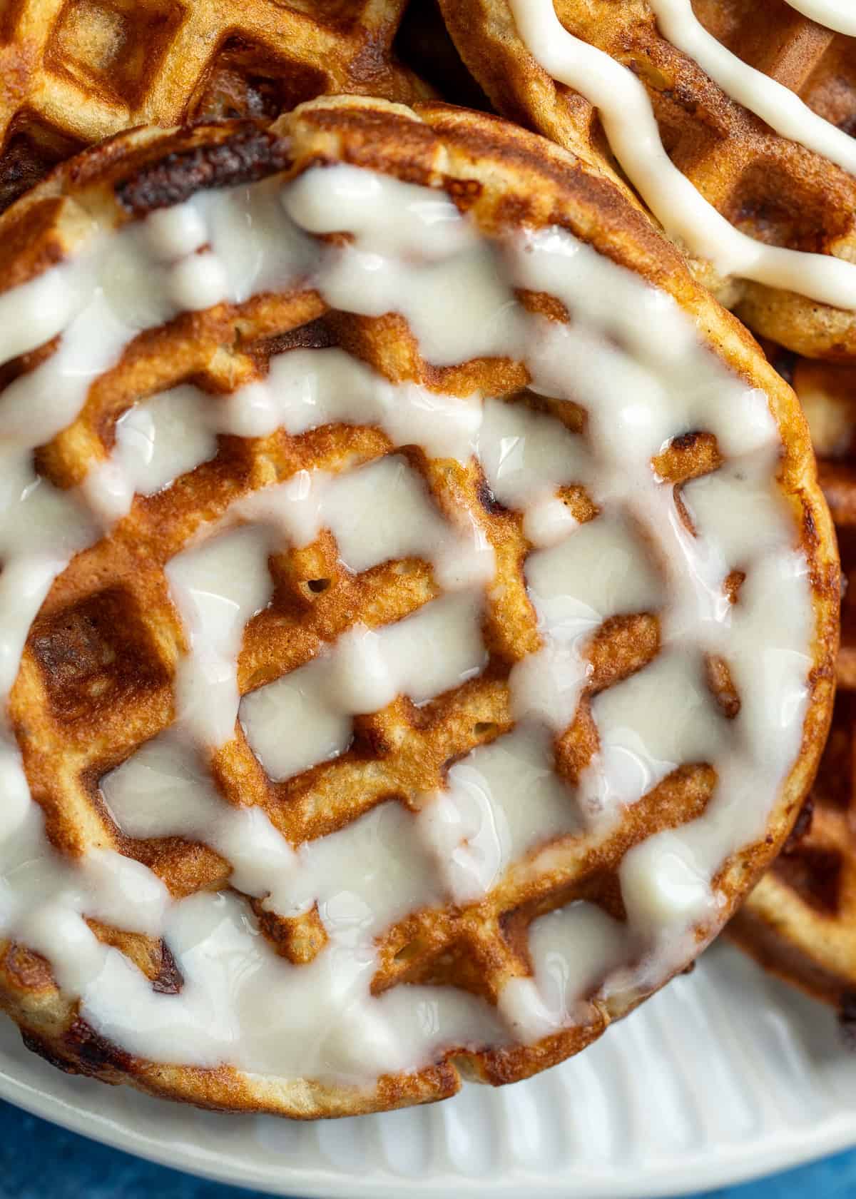 close up image of a keto cinnamon roll chaffle on a white plate