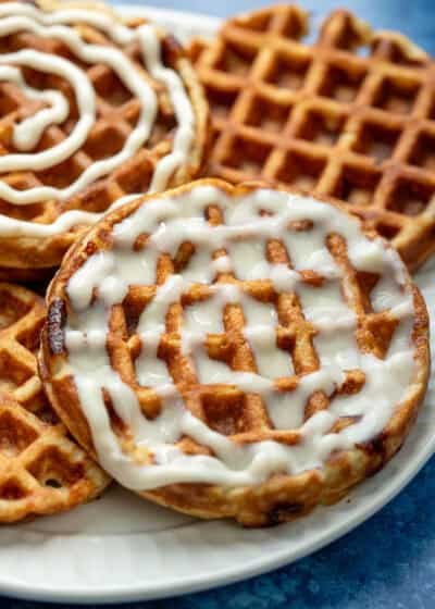 close, overhead image of 3 cinnamon roll chaffles on a white plate