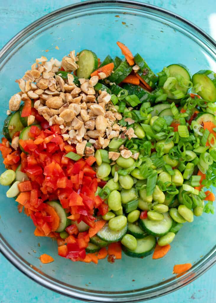 overhead shot of ingredients for cucumber carrot salad in a glass bowl