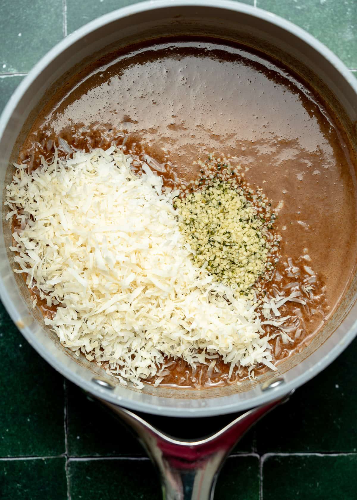cocoa powder, vanilla, and sweetener being added to sauce pan