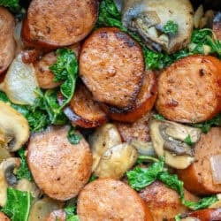 cooked andouille sausage and vegetable skillet in a cast iron skillet