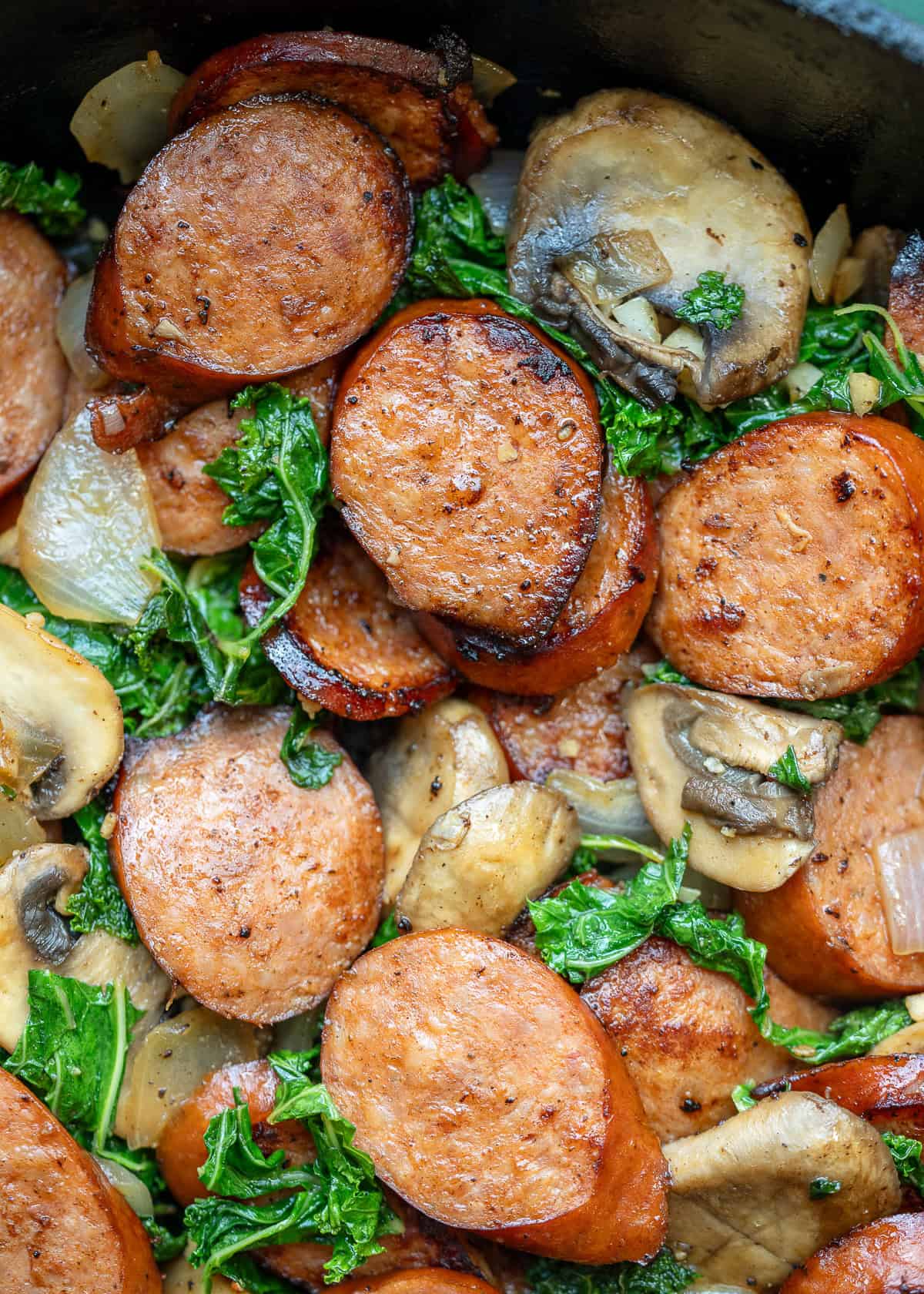 cooked andouille sausage and vegetable skillet in a cast iron skillet