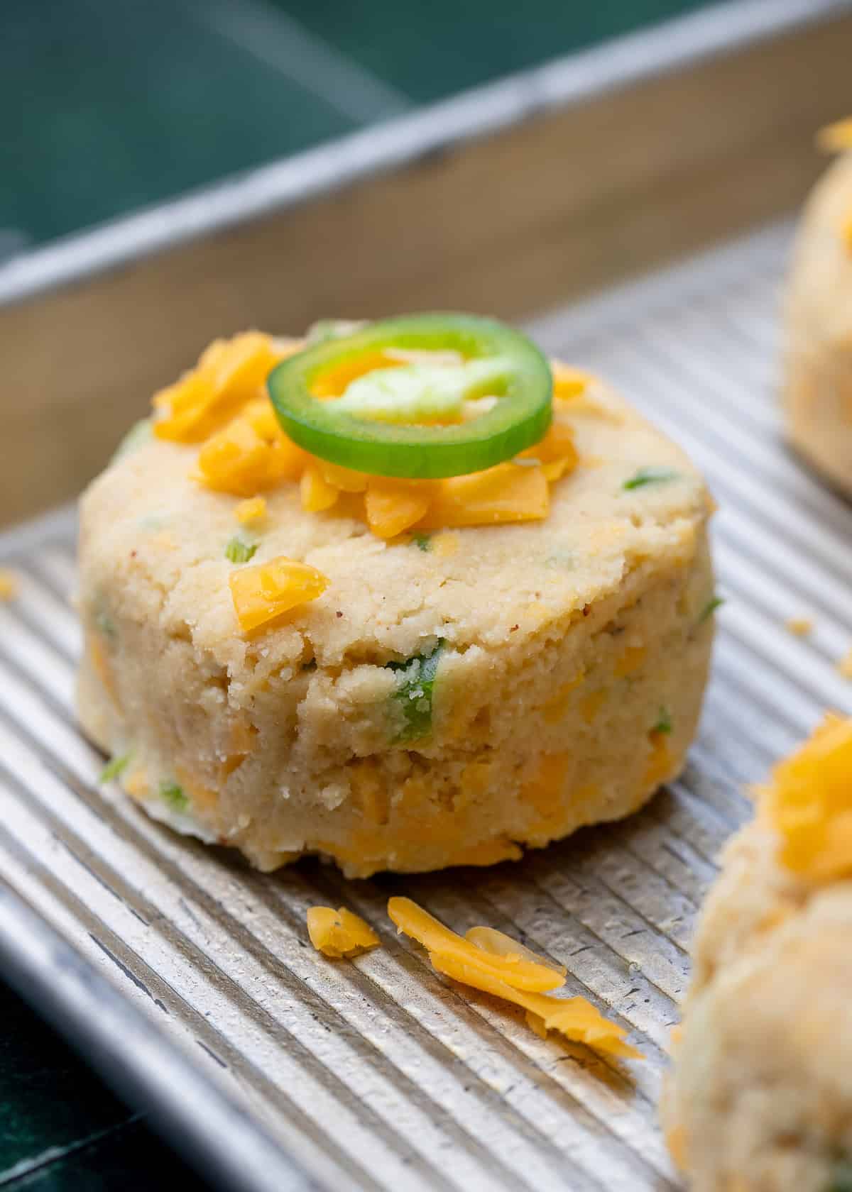 jalapeno cheddar biscuit on a sheet pan prior to cooking
