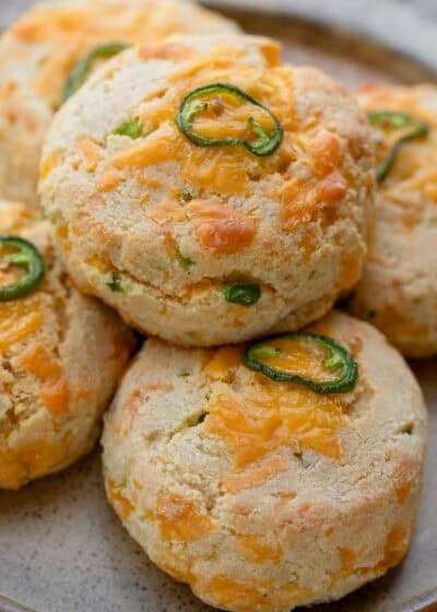 cooked jalapeno cheddar keto biscuits stacked on top of one another