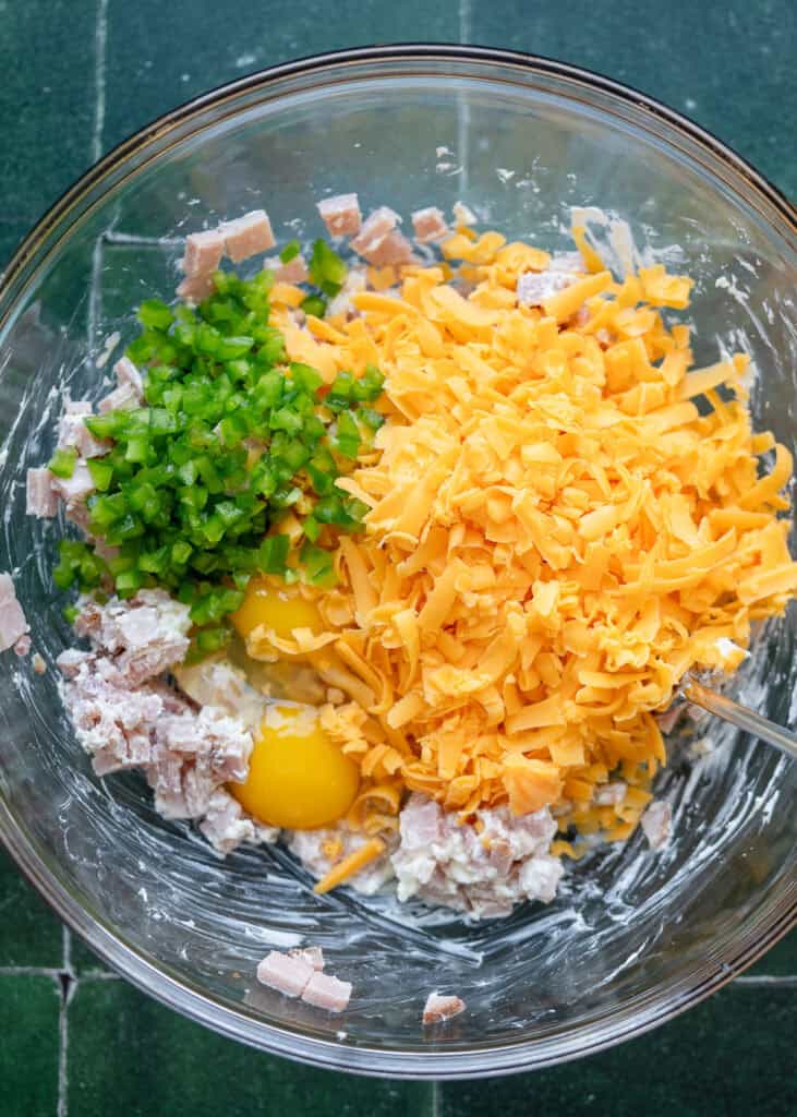 ham, cheddar, and jalapeno mix in a clear mixing bowl